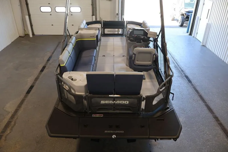 Slide: The Image of 2026 Sea-Doo Switch Cruise Limited 18 pontoon boat interior in a garage setting. - 10