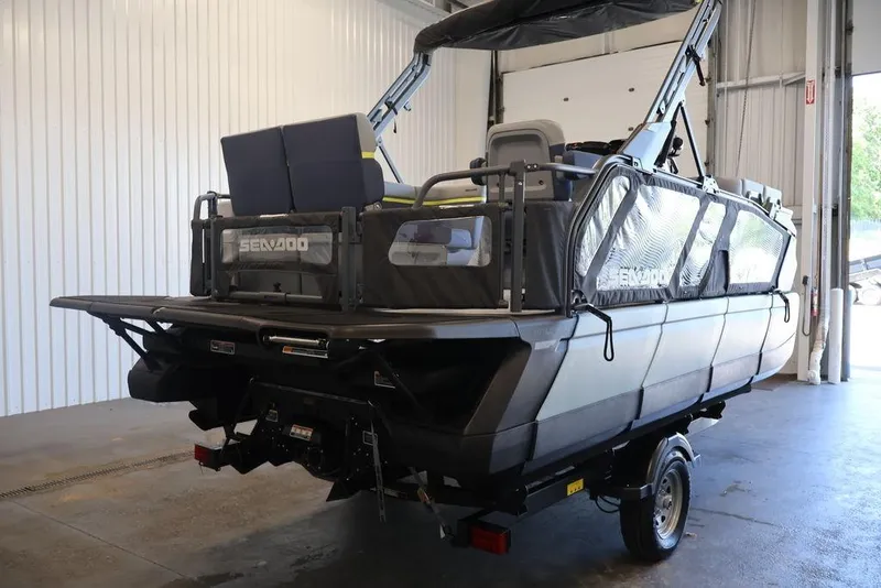 Slide: The Image of 2026 Sea-Doo Switch Cruise Limited 18 pontoon boat in a garage setting. - 5