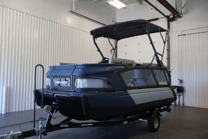 Slide: The Image of 2026 Sea-Doo Switch Cruise Limited 18 pontoon boat in a garage setting. - 35