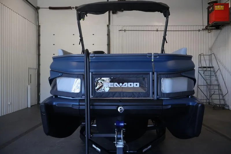 Slide: The Image of 2026 Sea-Doo Switch Cruise Limited 18 in a garage, front view. - 2