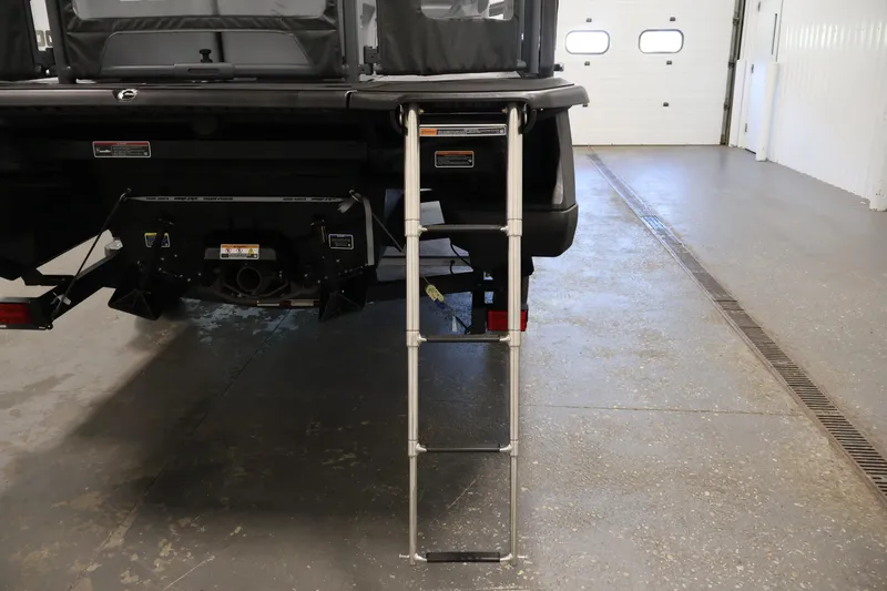 Slide: The Image of Rear view of 2026 Sea-Doo Switch Fish 18 with ladder in a garage setting. - 46