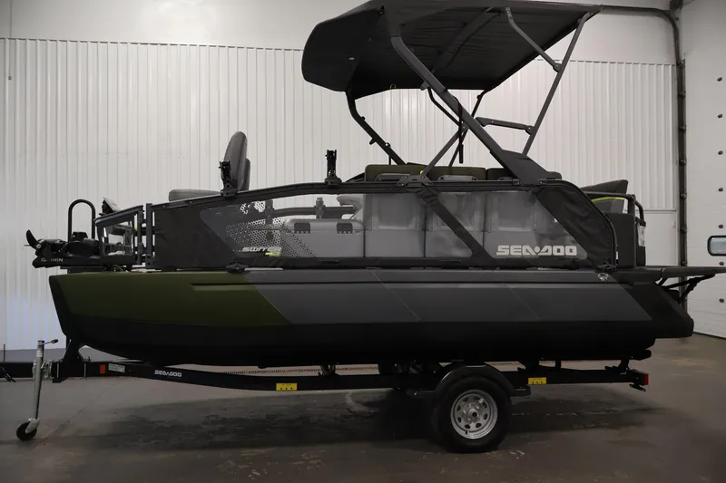 Slide: The Image of 2026 Sea-Doo Switch Fish 18 pontoon boat in a showroom, side view. - 15