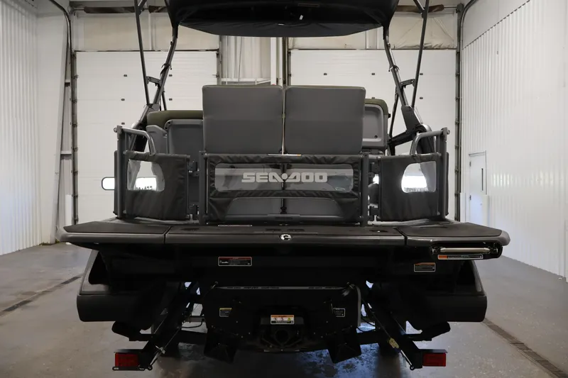 Slide: The Image of 2026 Sea-Doo Switch Fish 18, rear view in a garage setting. - 13