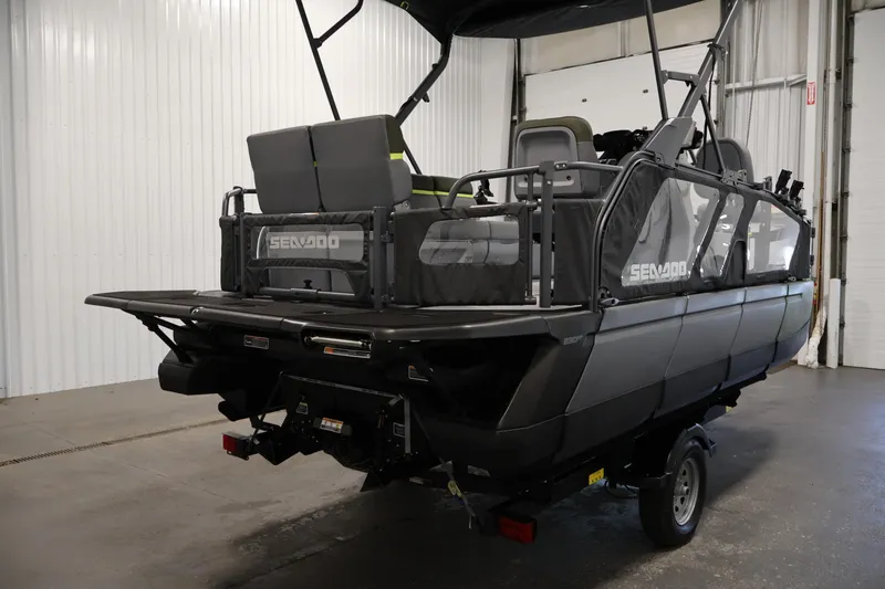 Slide: The Image of 2026 Sea-Doo Switch Fish 18 pontoon boat in a showroom, rear view. - 12