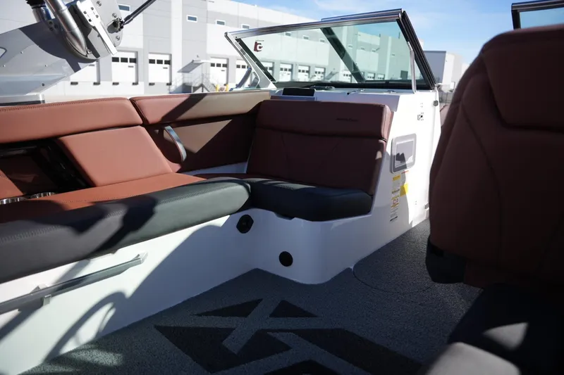 Slide: The Image of 2019 MasterCraft XT22 boat interior with brown and black seating, modern design. - 23