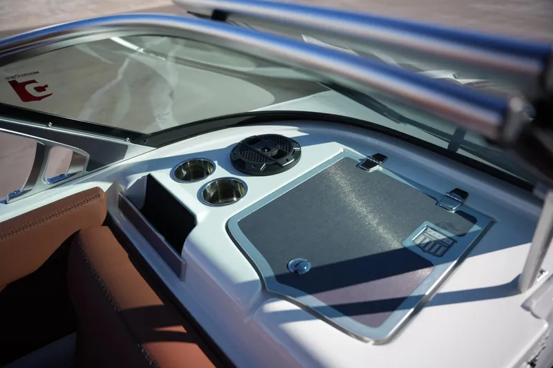 Slide: The Image of 2019 MasterCraft XT22 boat dashboard with cup holders and speaker. - 28