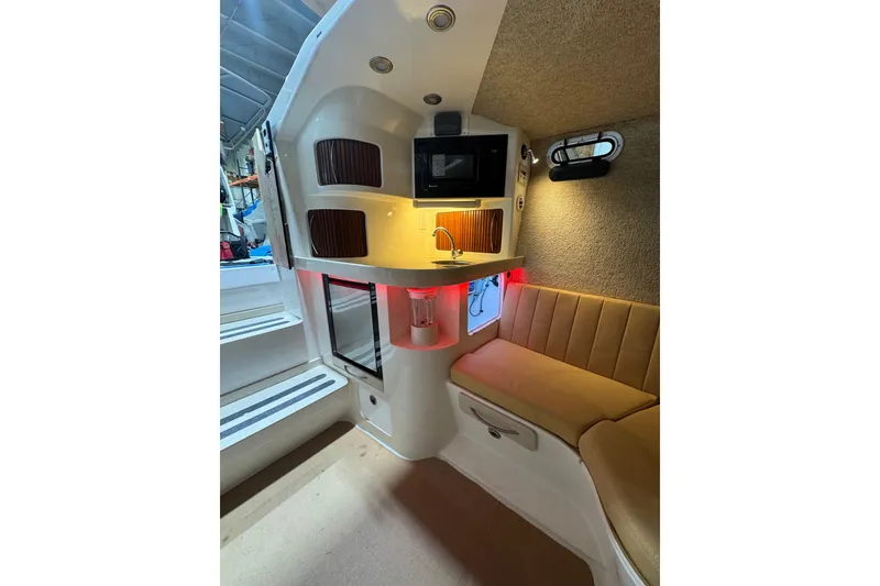 Slide: The Image of Interior of 2008 Don Smith 45 boat with seating, kitchenette, and ambient lighting. - 12
