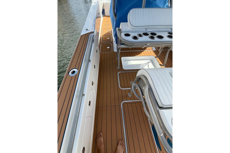 Slide: The Image of Luxury boat deck with white seating, teak flooring, and cup holders, Don Smith 45, 2008 model. - 19
