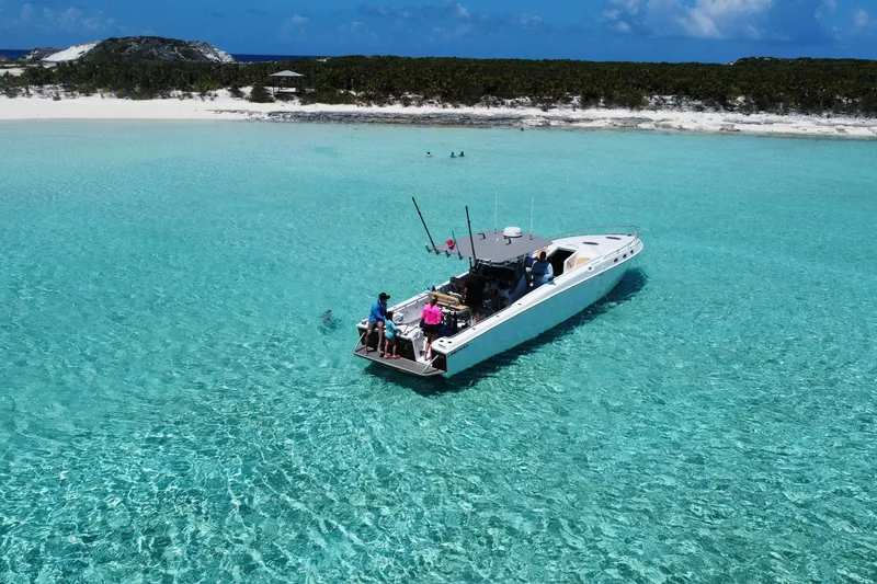 Slide: The Image of A Don Smith 45 boat from 2008 on clear turquoise waters near a sandy beach. - 5