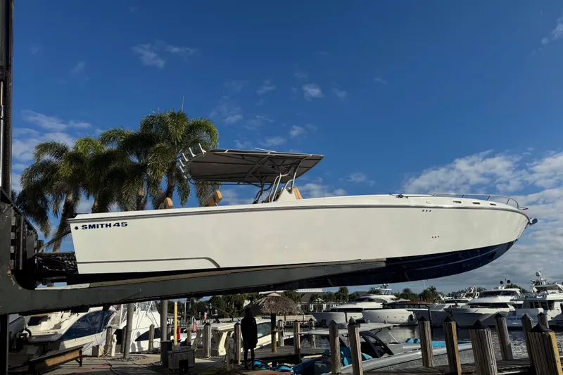 Slide: The Image of 2008 Don Smith 45 boat lifted at marina, clear sky background. - 8