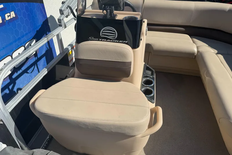 Slide: The Image of 2019 Sun Tracker Bass Buggy 16 DLX boat interior with beige seating and cup holders. - 11
