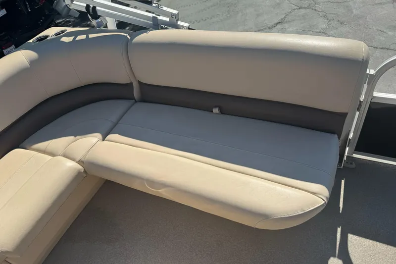 Slide: The Image of 2019 Sun Tracker Bass Buggy 16 DLX boat seating, beige upholstery, outdoor setting. - 13