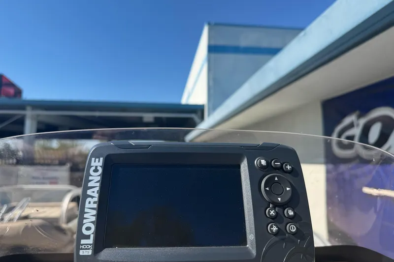 Slide: The Image of Lowrance fish finder on 2019 Sun Tracker Bass Buggy 16 DLX boat, clear blue sky background. - 17