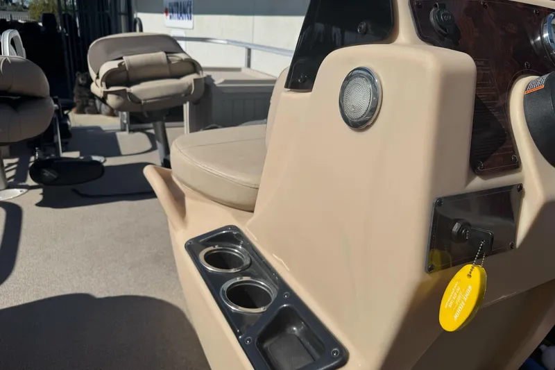 Slide: The Image of 2019 Sun Tracker Bass Buggy 16 DLX interior with beige seating and cup holders. - 18