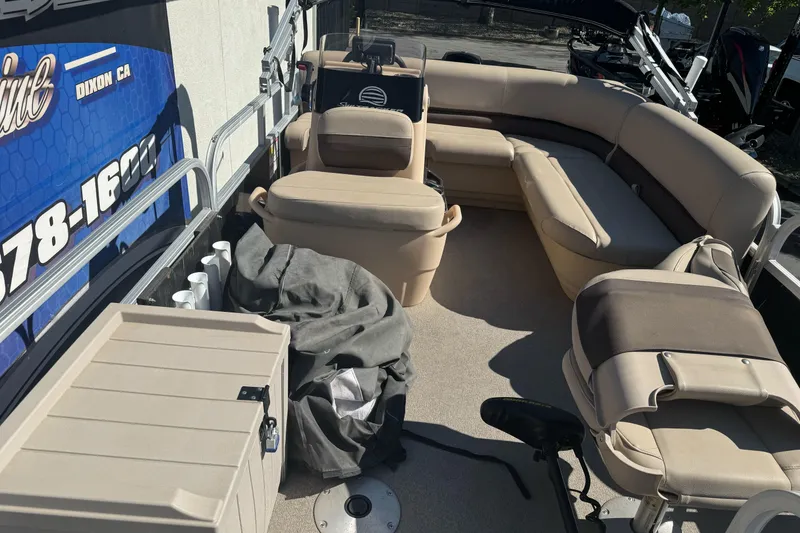Slide: The Image of 2019 Sun Tracker Bass Buggy 16 DLX interior with beige seating and storage compartments. - 8
