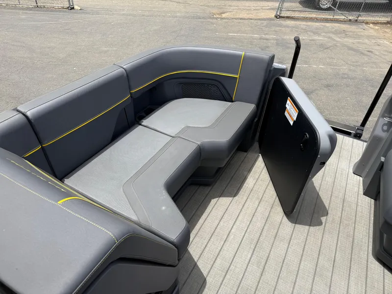 Slide: The Image of 2025 Manitou Explore boat interior with gray seating and yellow accents. - 1