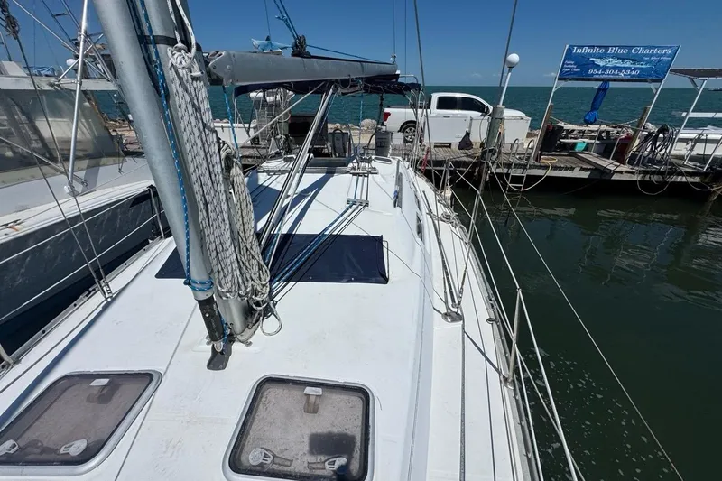 Slide: The Image of 2005 Beneteau Oceanis Clipper 373 sailboat docked at marina with clear blue sky. - 20