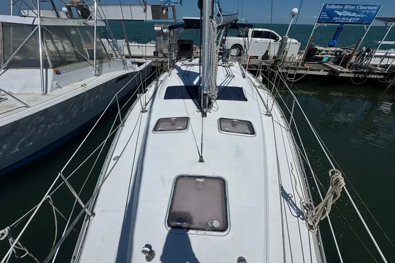 Slide: The Image of 2005 Beneteau Oceanis Clipper 373 sailboat docked at marina, viewed from deck. - 21