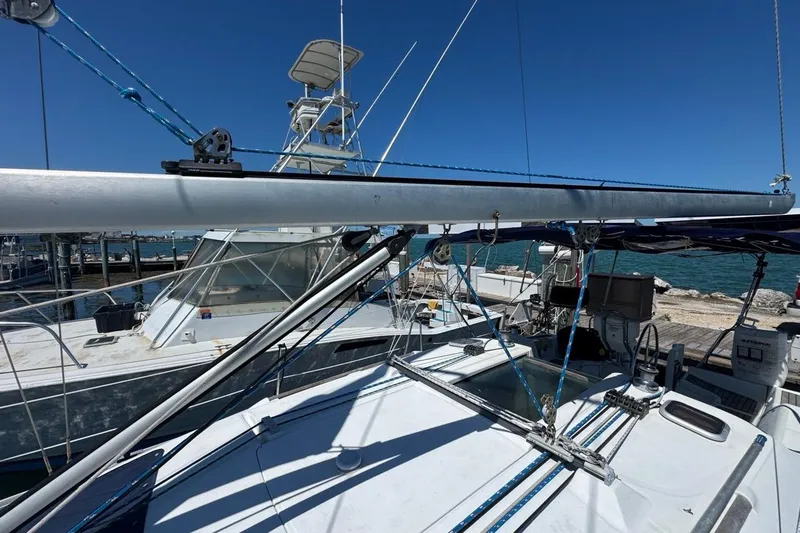 Slide: The Image of 2005 Beneteau Oceanis Clipper 373 sailboat docked at marina under clear blue sky. - 22