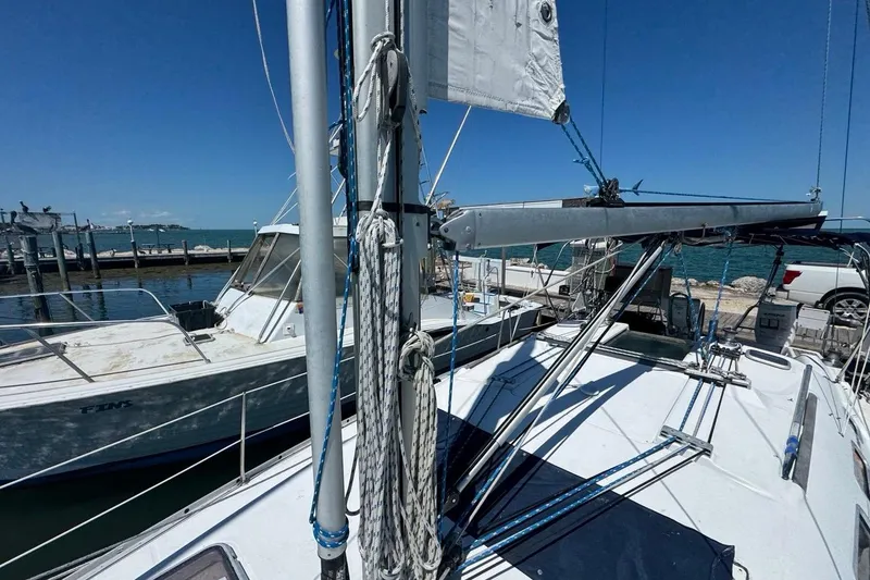 Slide: The Image of 2005 Beneteau Oceanis Clipper 373 sailboat docked at marina under clear blue sky. - 24