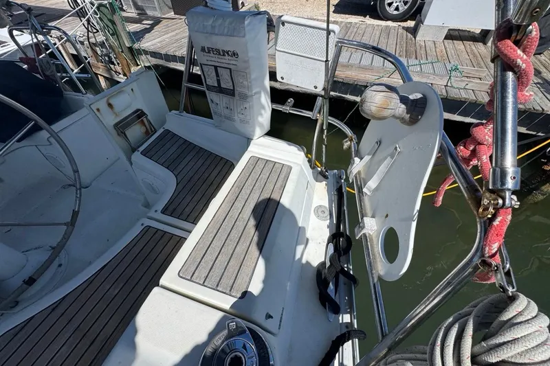 Slide: The Image of Cockpit of 2005 Beneteau Oceanis Clipper 373 sailboat with wooden seating and safety equipment. - 25