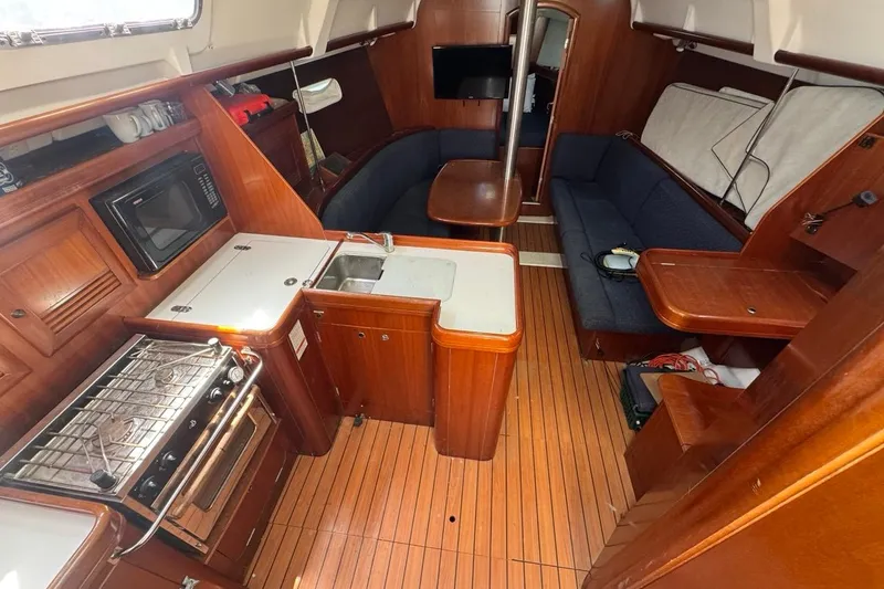 Slide: The Image of Interior of 2005 Beneteau Oceanis Clipper 373 sailboat with wood finish and compact kitchen. - 27