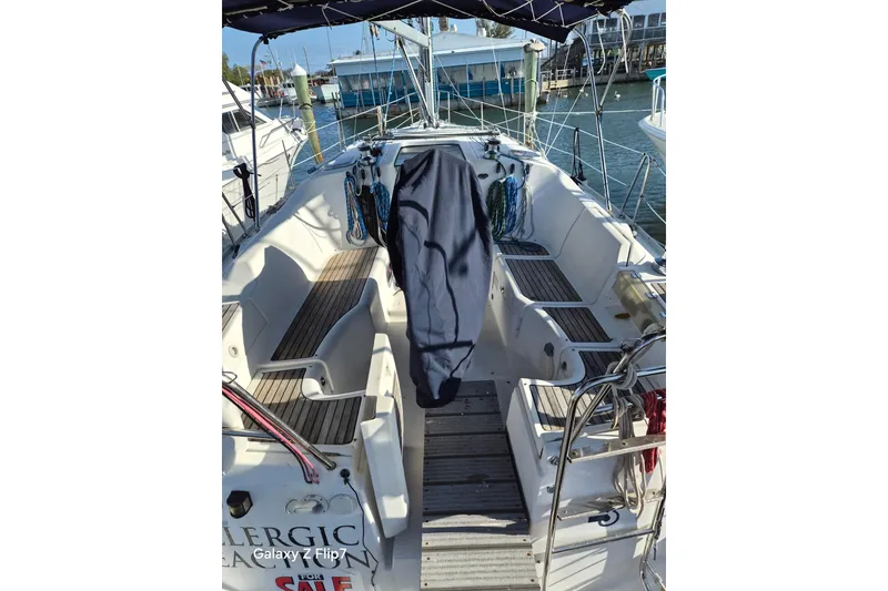 Slide: The Image of 2005 Beneteau Oceanis Clipper 373 sailboat cockpit with wooden seating and nautical equipment. - 3