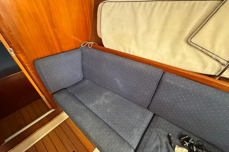 Slide: The Image of Interior of 2005 Beneteau Oceanis Clipper 373 with blue cushioned seating. - 31