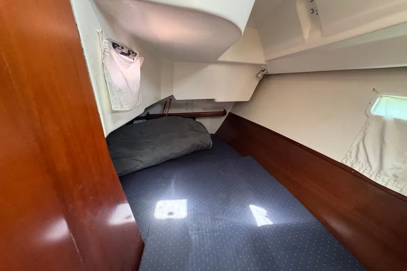Slide: The Image of Cozy cabin interior of 2005 Beneteau Oceanis Clipper 373 sailboat with wooden accents. - 34