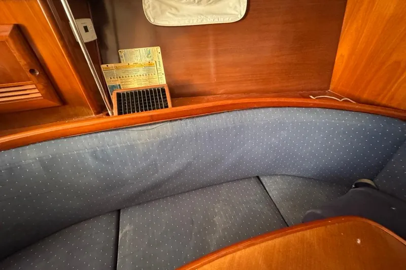 Slide: The Image of Interior of 2005 Beneteau Oceanis Clipper 373 with blue cushioned seating and wooden finish. - 37
