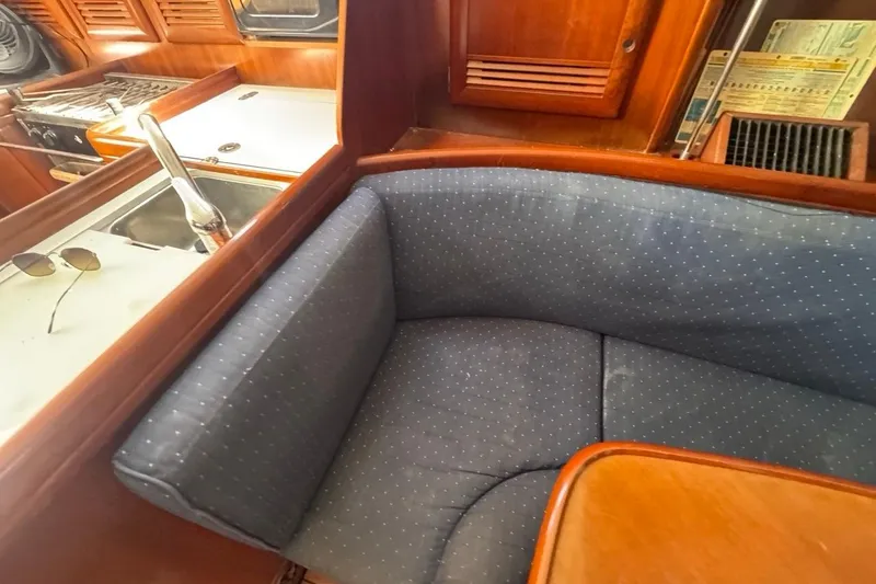 Slide: The Image of Interior of 2005 Beneteau Oceanis Clipper 373 yacht with cozy seating and kitchen area. - 38