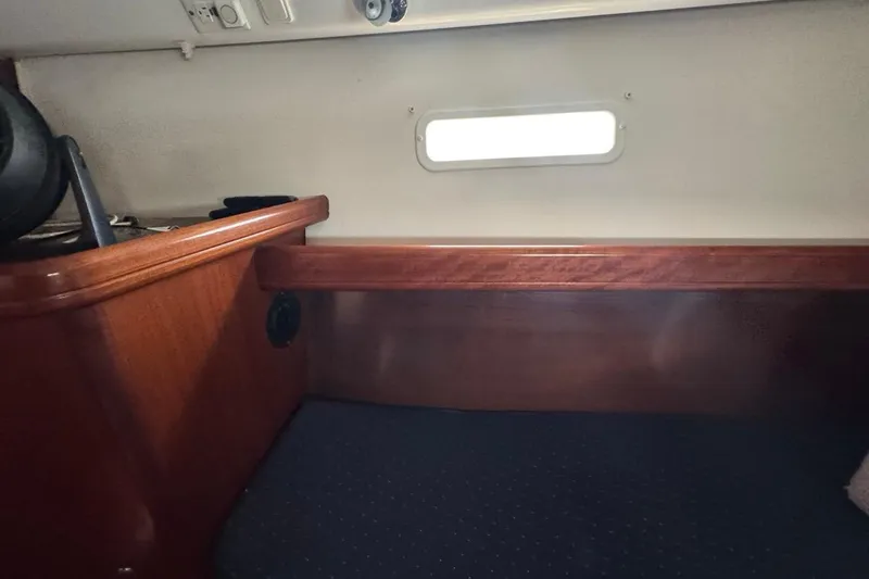 Slide: The Image of Interior cabin of 2005 Beneteau Oceanis Clipper 373 with wooden finish and small window. - 40