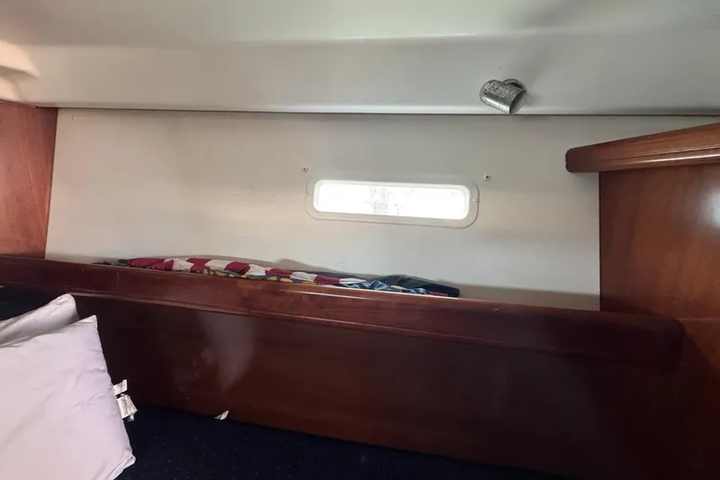 Slide: The Image of Interior cabin of 2005 Beneteau Oceanis Clipper 373 with wooden finish and small window. - 42
