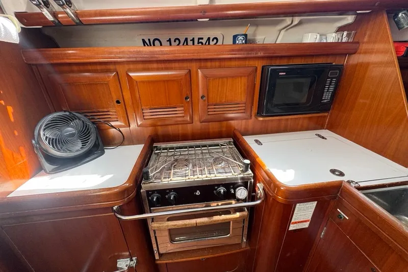 Slide: The Image of 2005 Beneteau Oceanis Clipper 373 galley with stove, microwave, and fan. - 43
