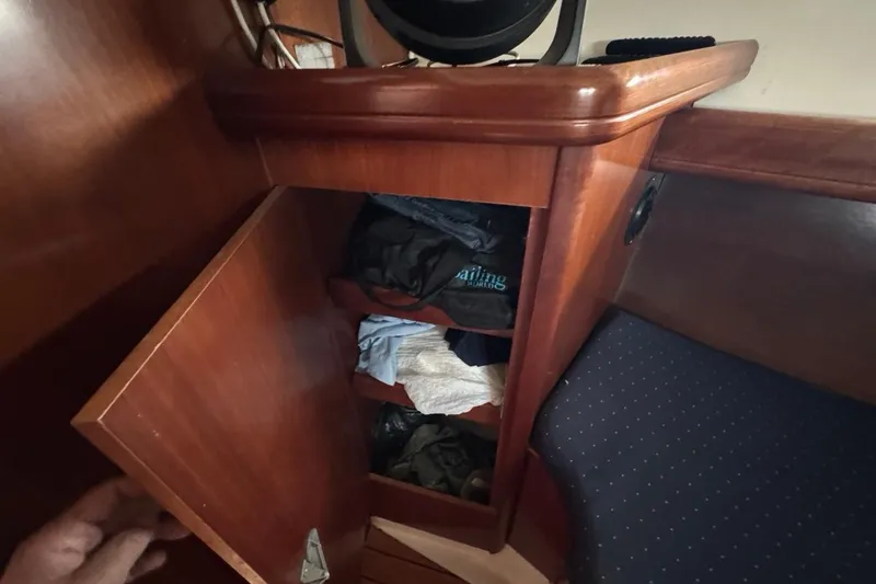 Slide: The Image of Wooden cabinet with clothes inside on a 2005 Beneteau Oceanis Clipper 373 yacht. - 44