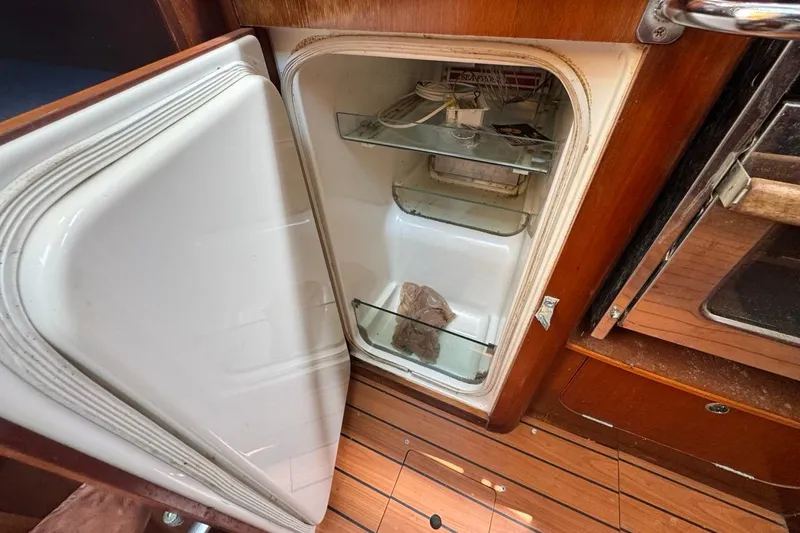 Slide: The Image of Open refrigerator inside 2005 Beneteau Oceanis Clipper 373 yacht, showcasing wooden interior. - 45