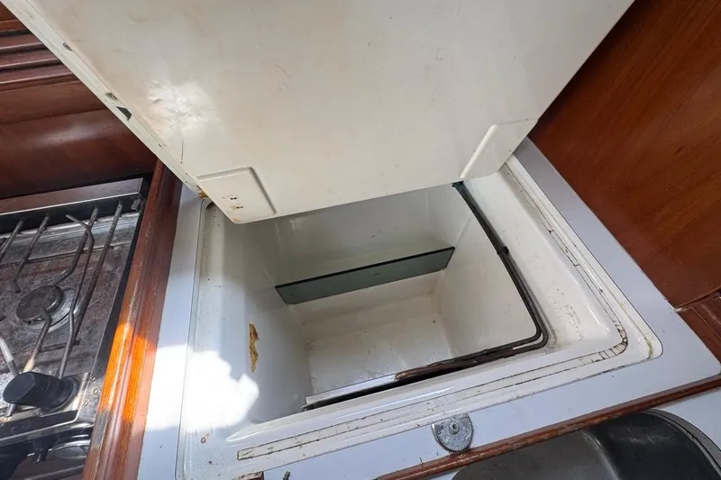 Slide: The Image of Open storage compartment in 2005 Beneteau Oceanis Clipper 373 yacht kitchen area. - 46