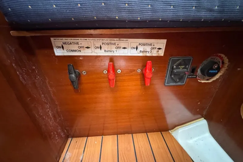 Slide: The Image of Electrical panel on a 2005 Beneteau Oceanis Clipper 373 sailboat, showing battery switches. - 49
