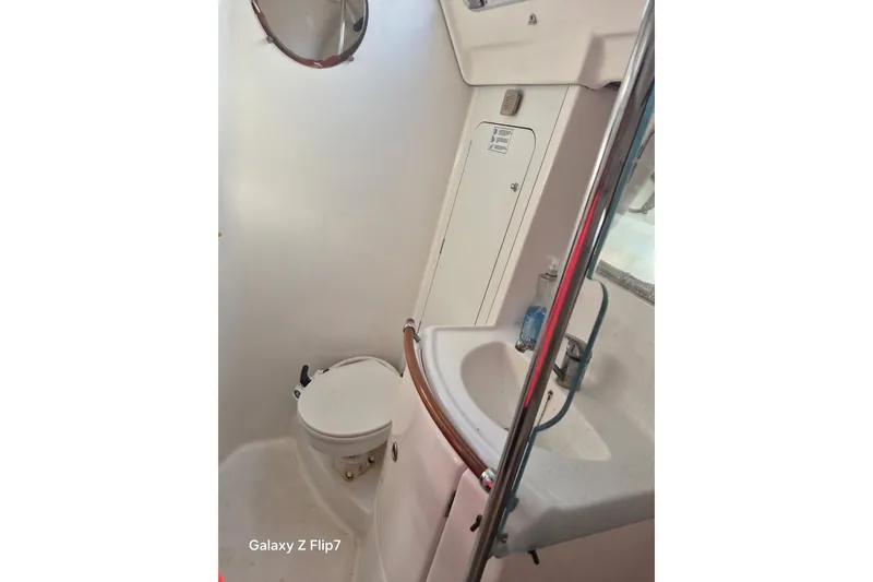 Slide: The Image of Bathroom interior of 2005 Beneteau Oceanis Clipper 373 yacht, featuring toilet and sink. - 5
