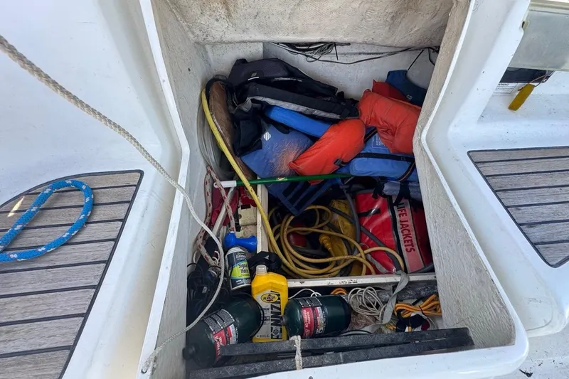 Slide: The Image of Storage compartment of 2005 Beneteau Oceanis Clipper 373 with life jackets and boating gear. - 54