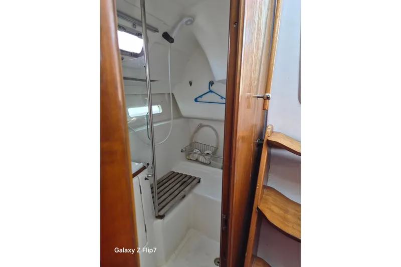 Slide: The Image of Interior of 2005 Beneteau Oceanis Clipper 373 yacht bathroom with shower and wooden accents. - 6