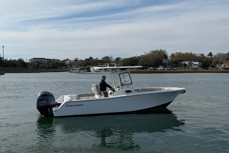 Slide: The Image of 2021 Sportsman Heritage 251 Center Console boat on calm water with scenic background. - 10