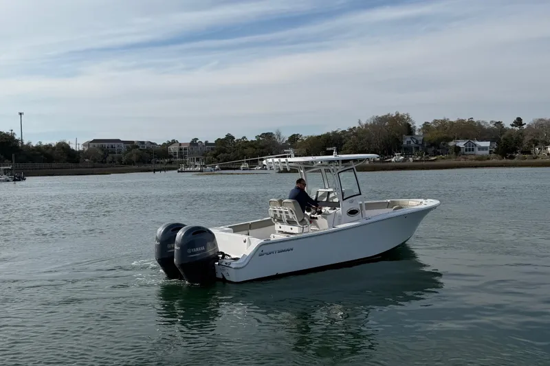 Slide: The Image of 2021 Sportsman Heritage 251 Center Console boat cruising on calm waters. - 11