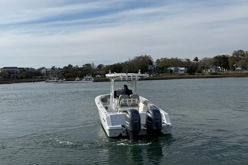 Slide: The Image of 2021 Sportsman Heritage 251 Center Console boat cruising on a calm waterway. - 17