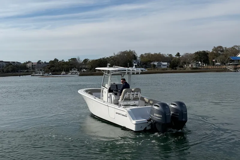 Slide: The Image of 2021 Sportsman Heritage 251 Center Console boat on calm water with twin Yamaha engines. - 18
