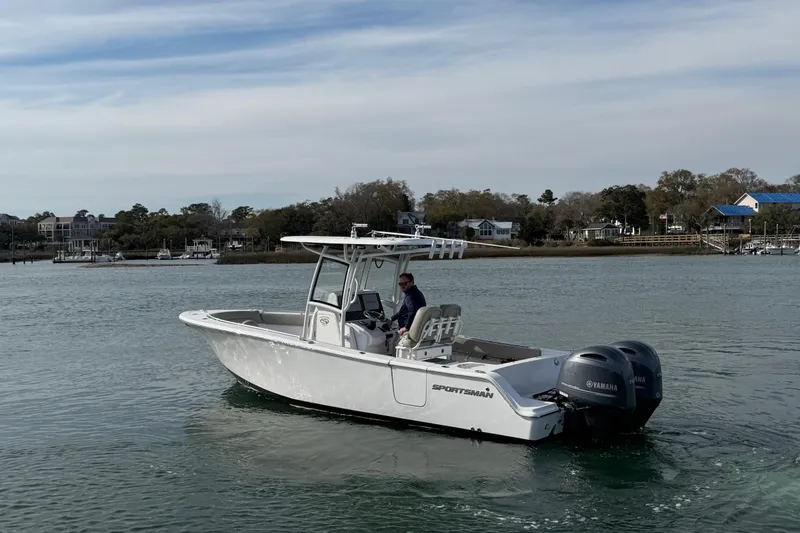 Slide: The Image of 2021 Sportsman Heritage 251 Center Console boat cruising on a calm waterway. - 19