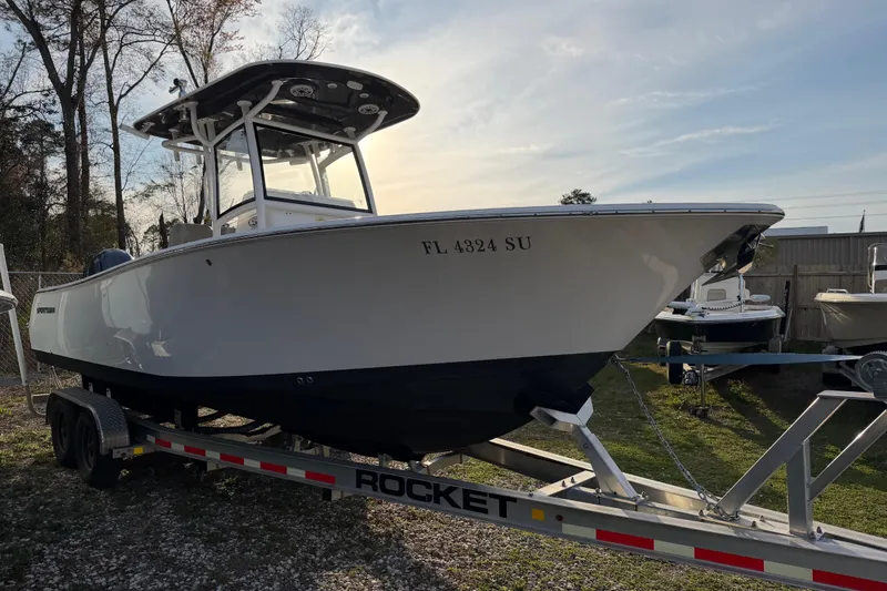 Slide: The Image of 2021 Sportsman Heritage 251 Center Console boat on trailer, parked outdoors. - 20
