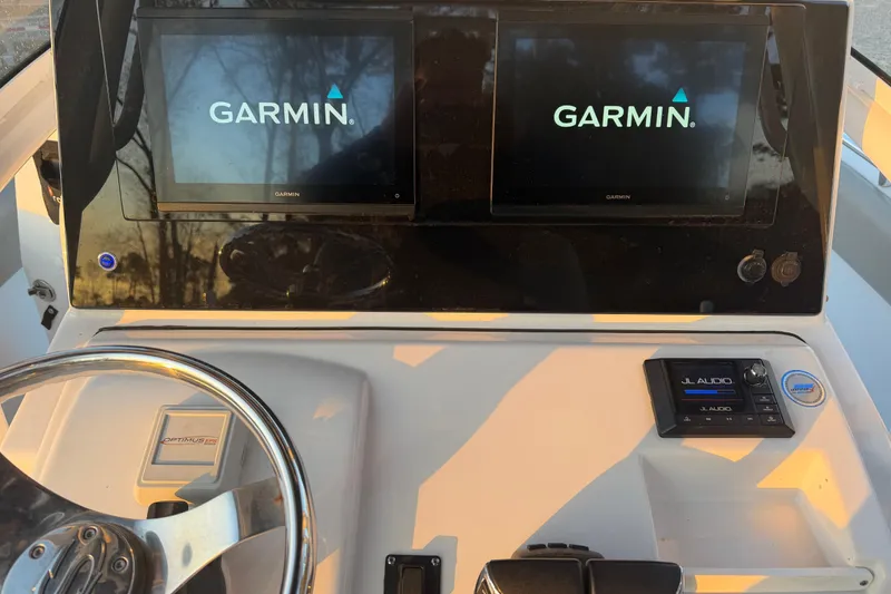 Slide: The Image of 2021 Sportsman Heritage 251 Center Console dashboard with Garmin displays and JL Audio system. - 21