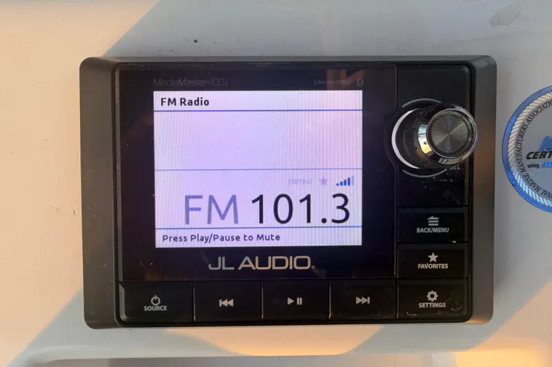 Slide: The Image of JL Audio radio display on Sportsman Heritage 251 Center Console, tuned to FM 101.3. - 23