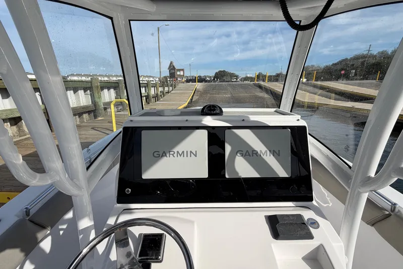 Slide: The Image of 2021 Sportsman Heritage 251 Center Console with Garmin displays at a dock. - 24